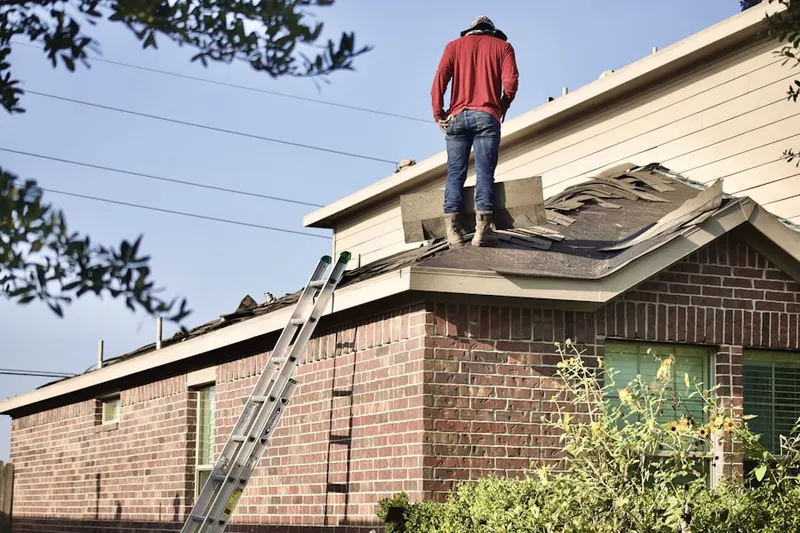 Professional roofer working on a residential roof in West Suffield